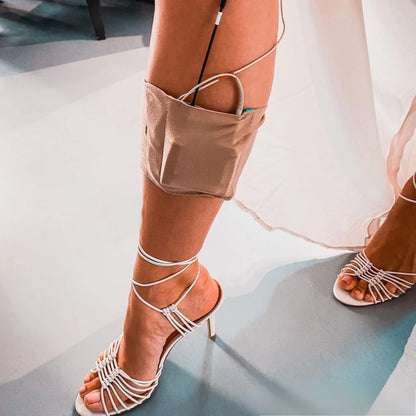 Beige ankle and calf strap with small front pouch, worn around the lower leg