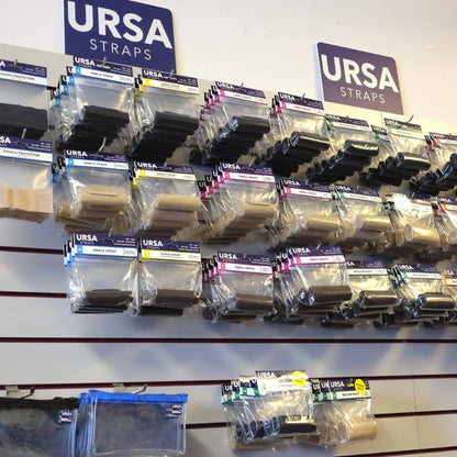 URSA Straps wall display of waist straps with single pouches in beige and black