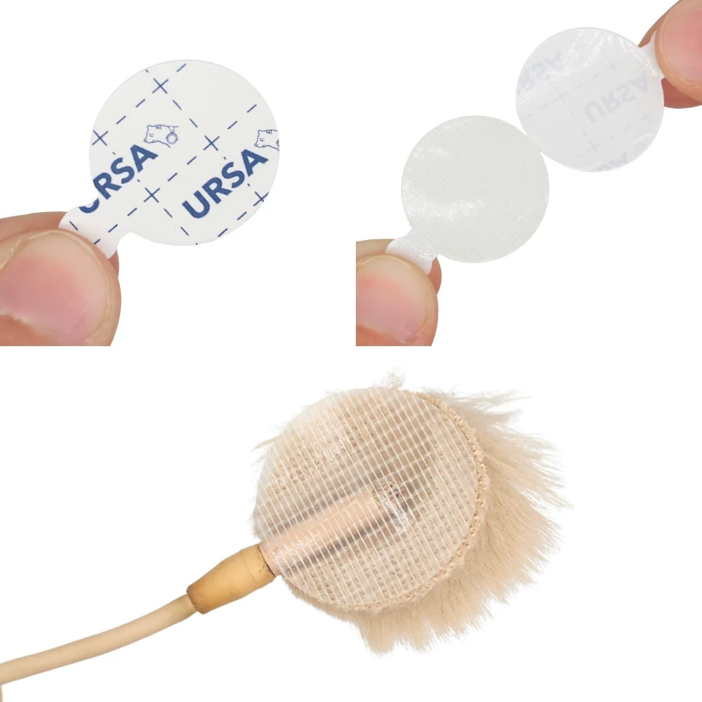 White round adhesive circles, unpeeled from backing, shown close-up