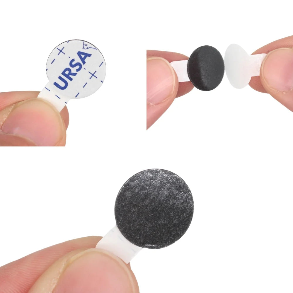 Fingers pressing a black round sticky pad onto white backing for placement