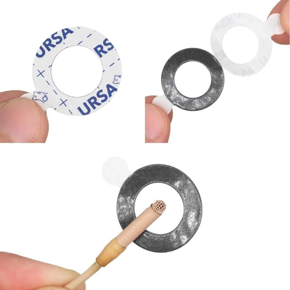 Circular adhesive zero rings in white and dark gray, shown being held