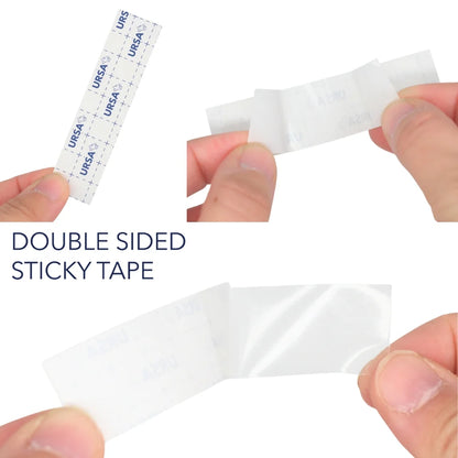 Double-sided sticky tape strip held between fingers, white backing