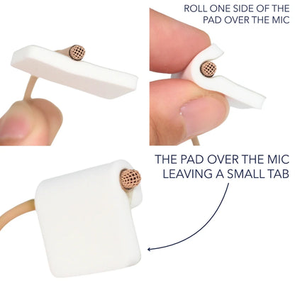White foam pad being rolled over a microphone, showing small edge tab