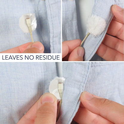 Adhesive circles attaching and lifting from light blue fabric, close-up