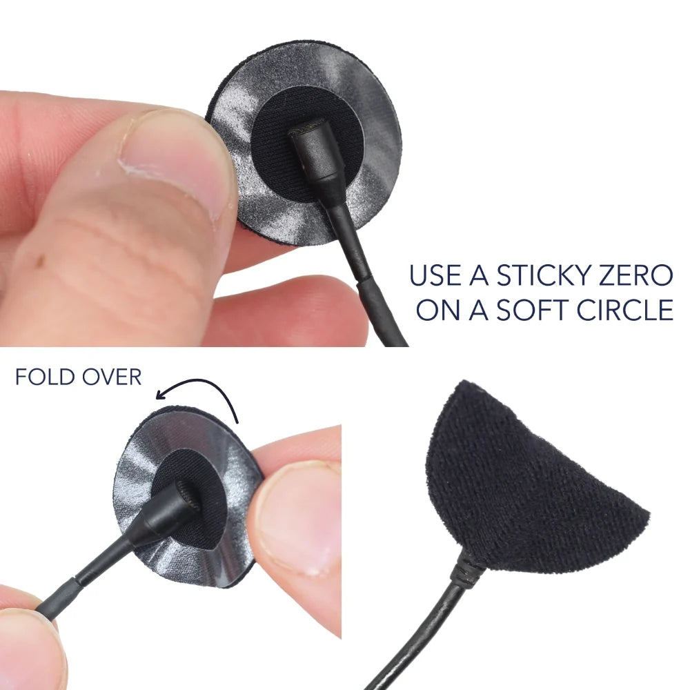 Dark fabric adhesive circle with stick and fold-over tab for applying to clothing