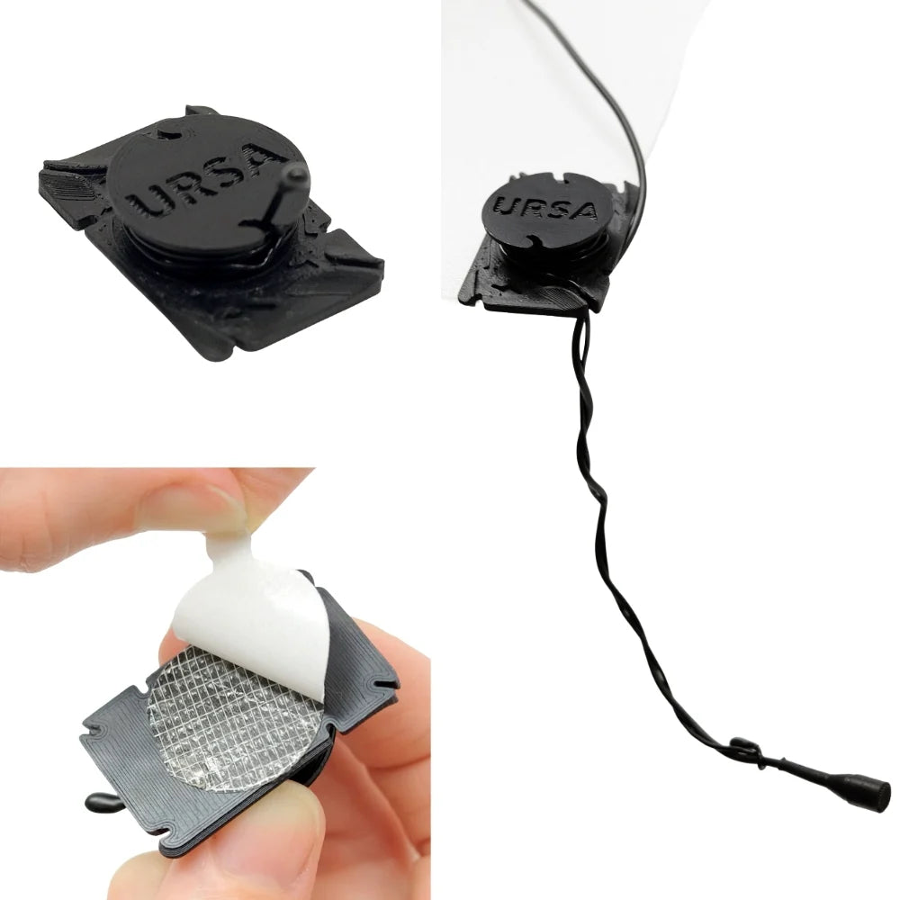 Black URSA clip mic with cable and mounting pads, shown close-up