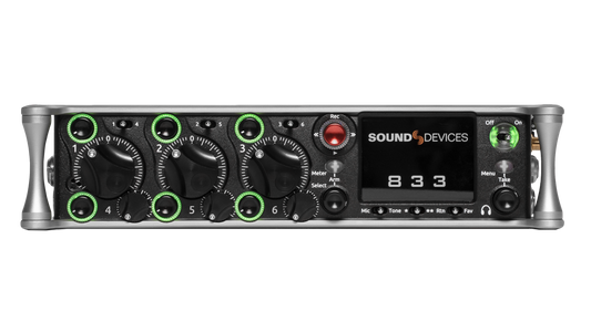 Black audio recorder front panel with knobs, meters, and green-ring controls