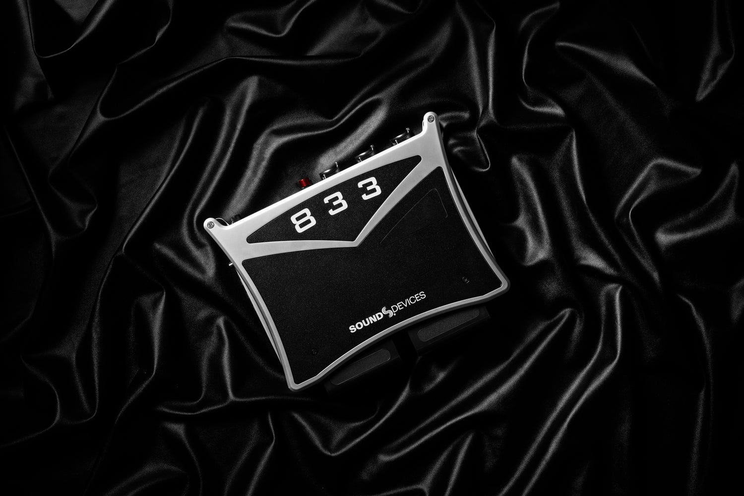 Black audio recorder with 833 label on top and SOUND DEVICES logo