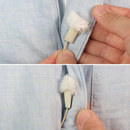 White fuzzy applicator tip with beige handle, held against light blue fabric