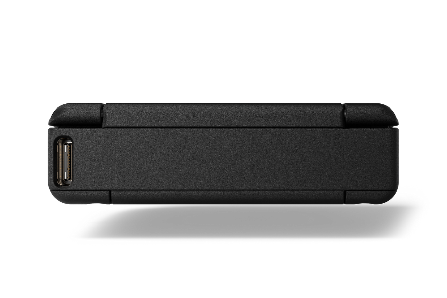 Portable audio device side with connector port openings and slim matte dark housing
