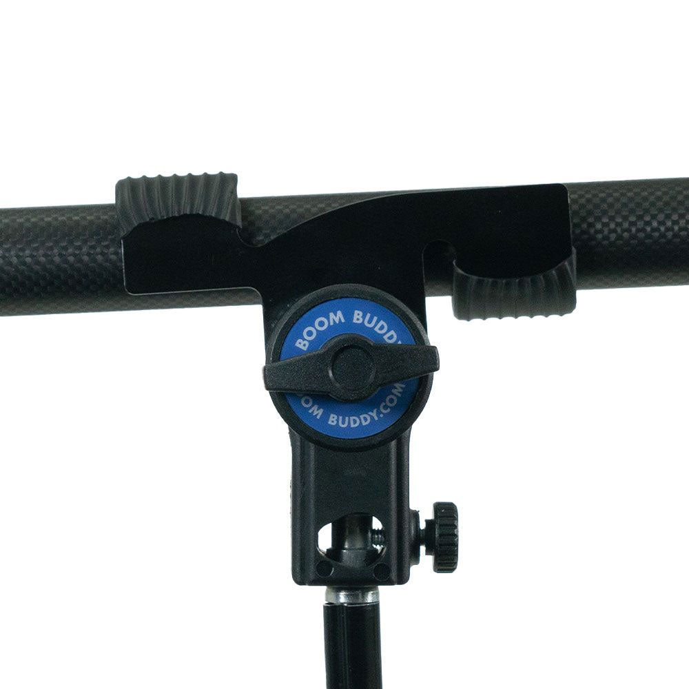 Boom pole holder with rubber-lined arms for securing a boom pole