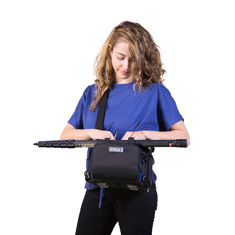 Small audio mixer bag worn on waist with black exterior and blue accents
