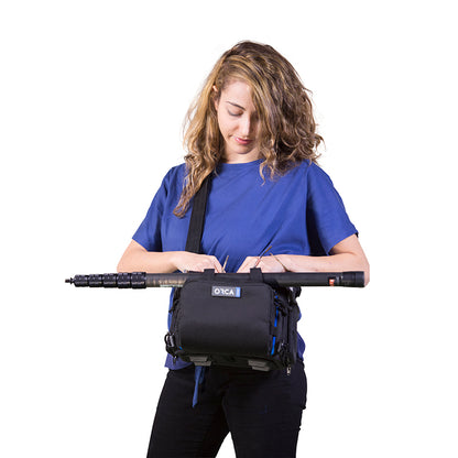 Small audio mixer bag worn on waist with black exterior and blue accents