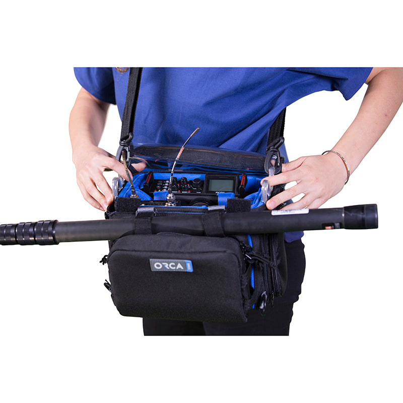 Small audio mixer bag with blue interior, worn with a shoulder strap