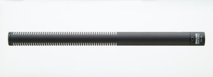 Shotgun microphone with long cylindrical body and side controls near the handle
