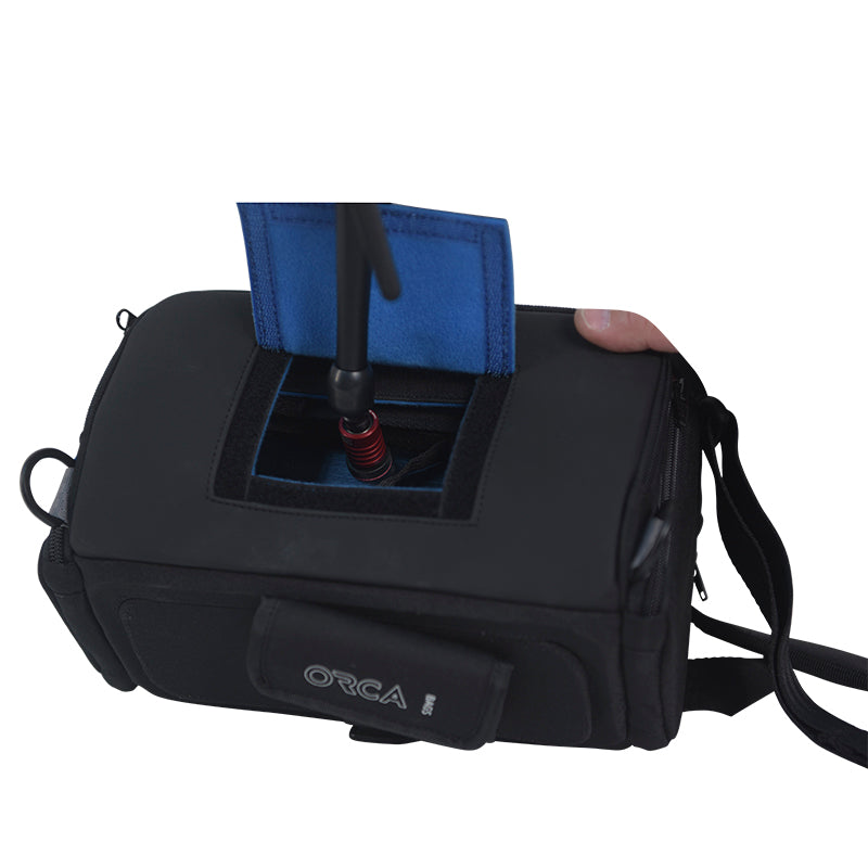 Audio mixer bag with front pocket opening, blue padded slot, and black top cover