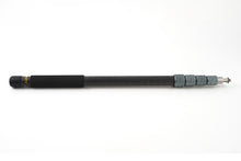 Boom pole extended with black handle section and silver adjustment hardware at tip.