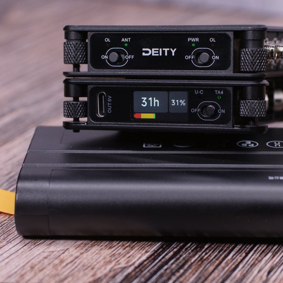 Stacked black RF distributor modules with PWR and 31h display on wood