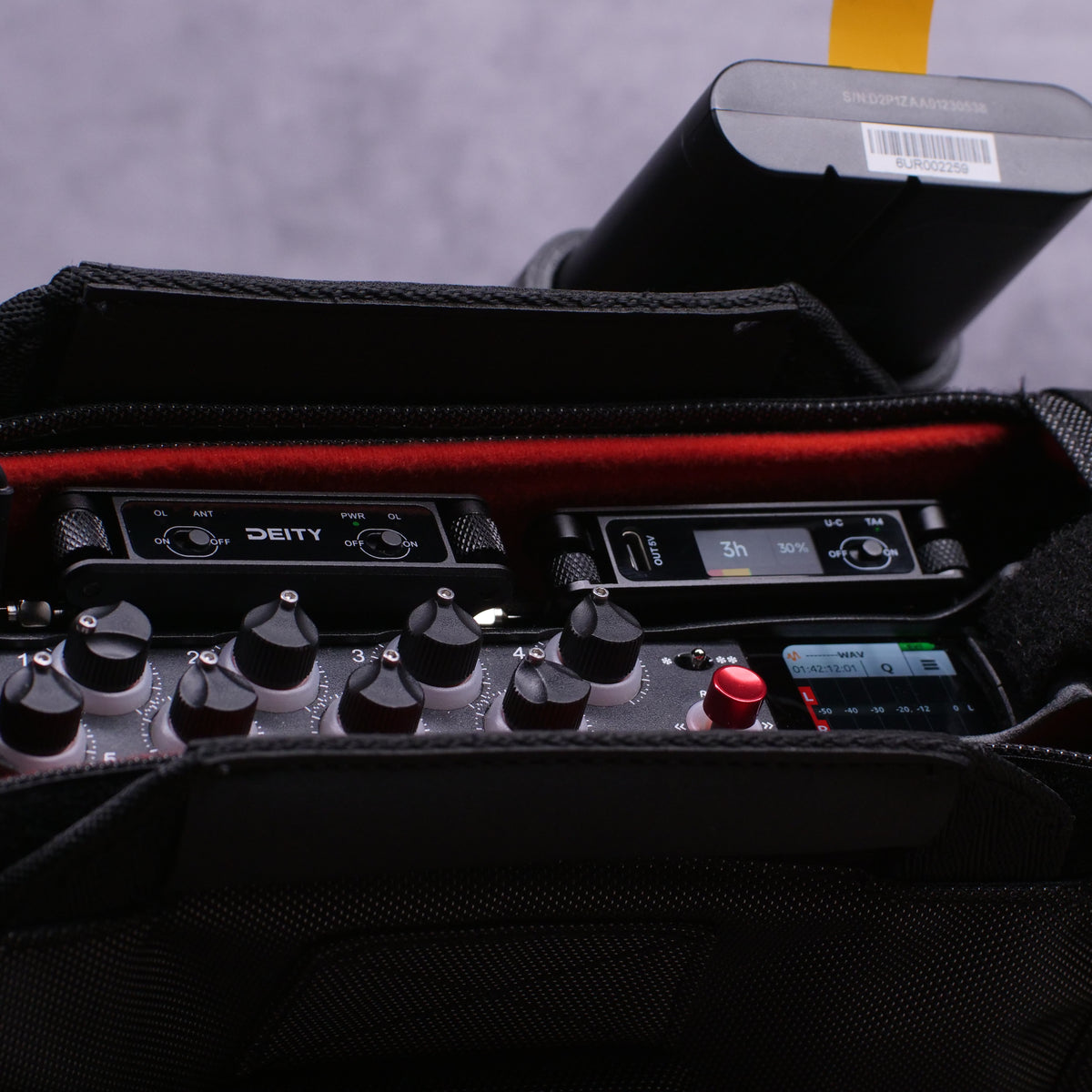RF distributor module with control knobs, small display, and red button in case