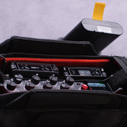 Black RF distributor module with control knobs and small screen inside carry case
