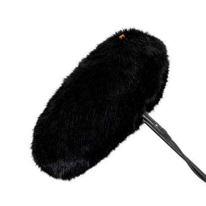 Black faux-fur wind jacket for microphone, close-up of plush fur cover