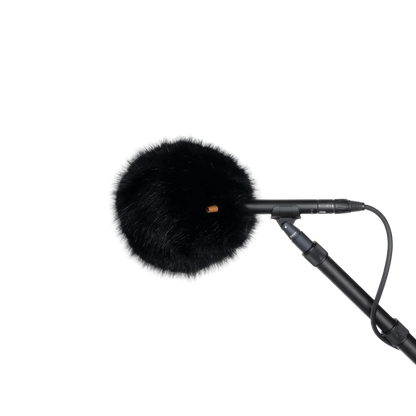 Black fur wind jacket with round front and small orange marker, on microphone