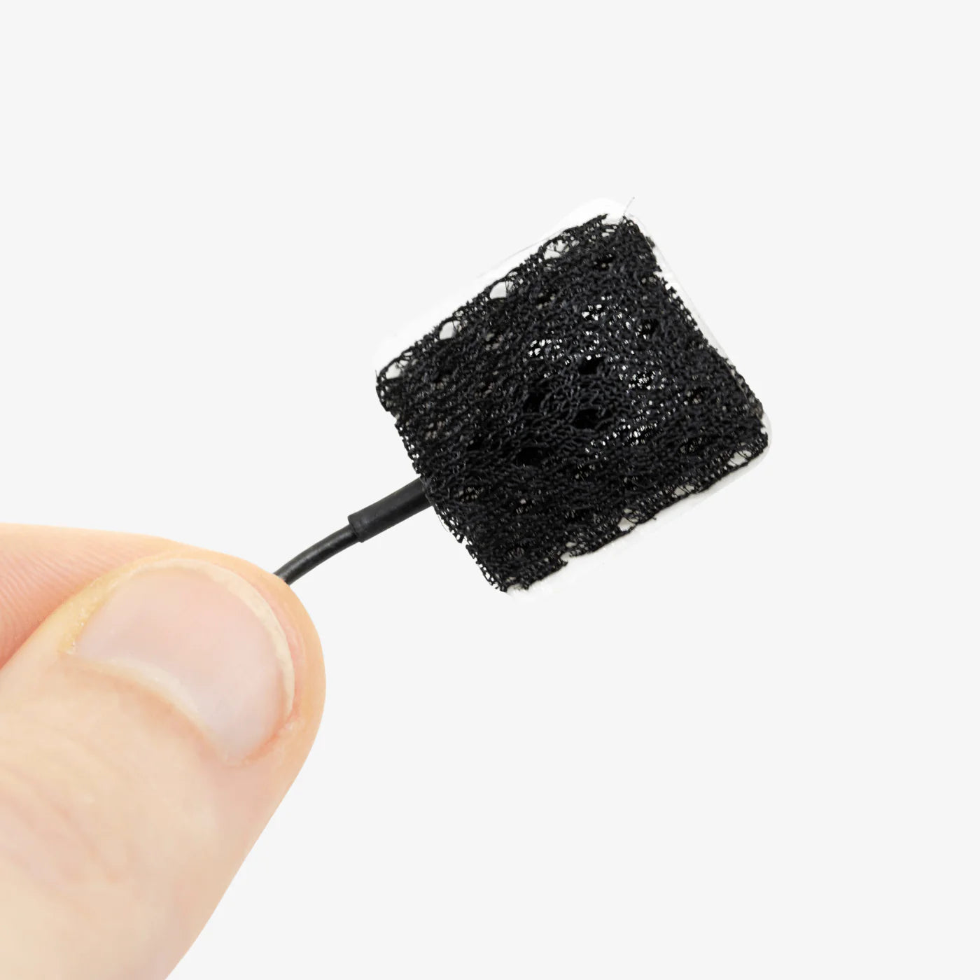 Black textured lav mic cover pad close-up on applicator