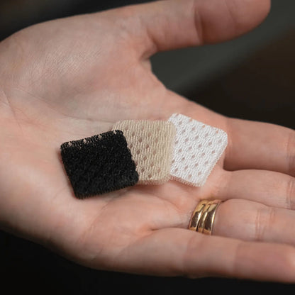 Lavalier microphone cover pads: black, beige, and white on open hand