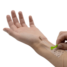Invisible skin tape being applied on arm with backing sheet