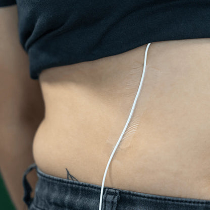 Invisible skin tape on skin beside waistband, thin clear strip