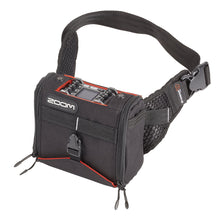 Black audio recorder sling bag with orange interior, padded compartments and adjustable strap