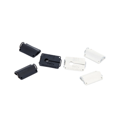 Assorted black and white lav microphone concealer clips with rectangular faceplates