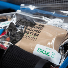 Clear lav mic pouch with printed label, containing coiled audio cable.