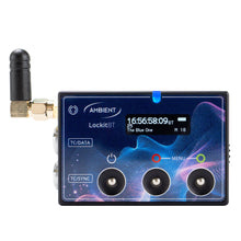 Timecode sync generator close-up with blue touchscreen, antenna, and three BNC ports