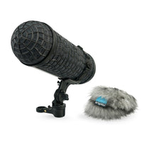 Dark handheld microphone with gray furry windscreen, shock mount, and clip stand
