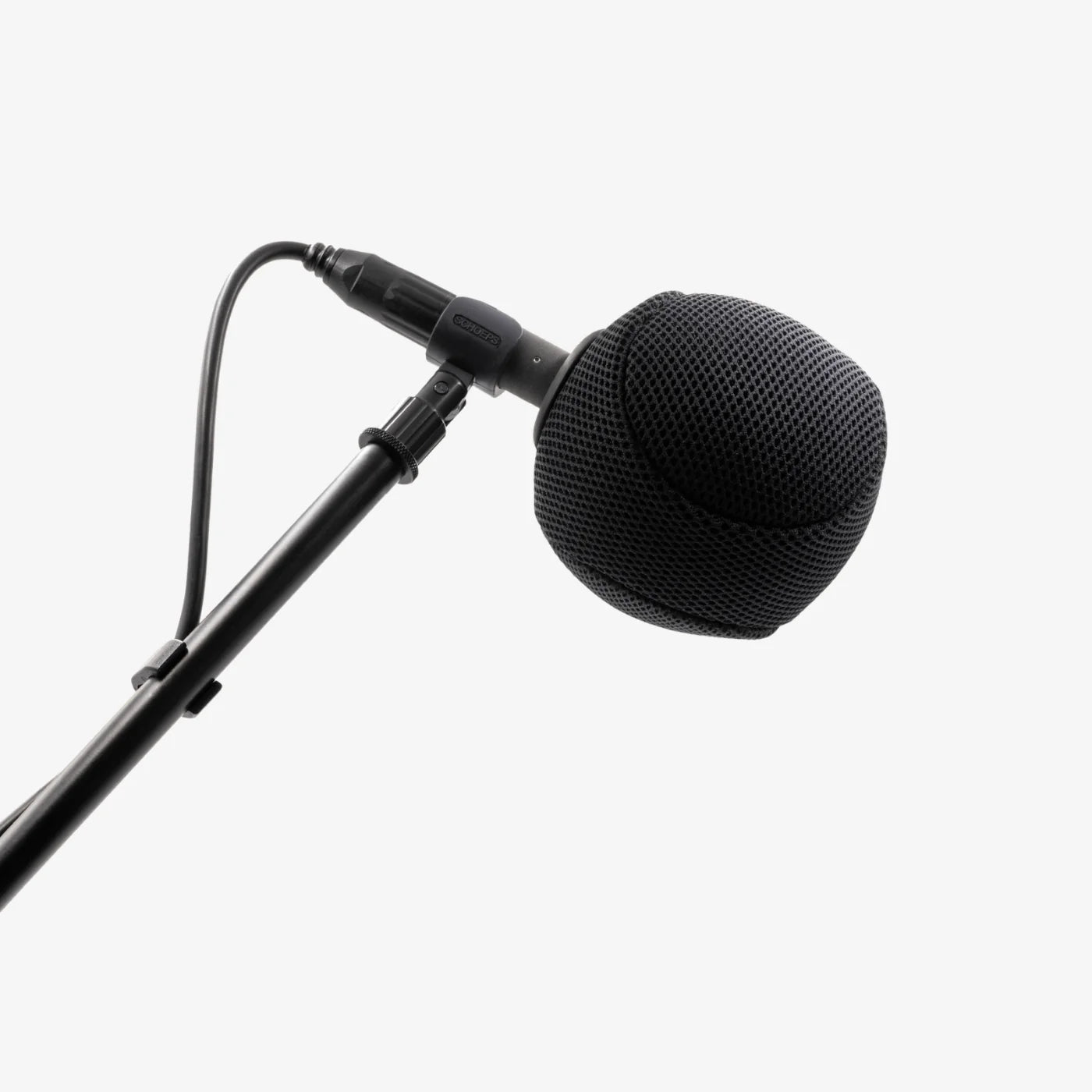 Black mesh microphone spacer ball mounted on a studio microphone