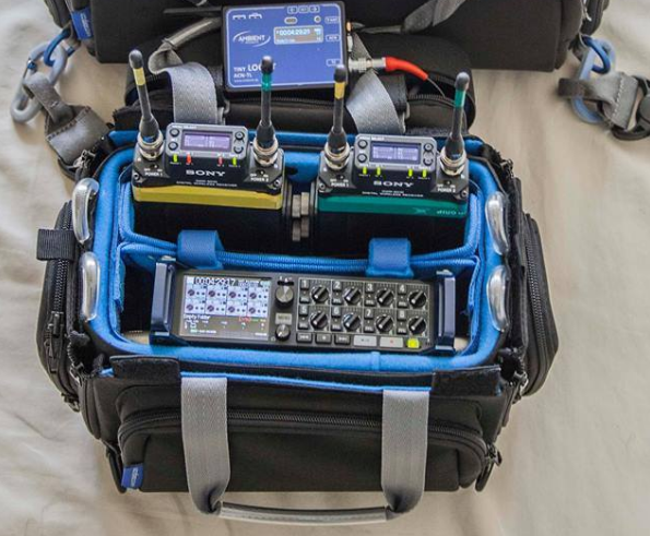 Audio mixer bag interior with blue lining and multiple handheld receivers