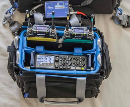 Audio mixer bag interior with blue lining and multiple handheld receivers