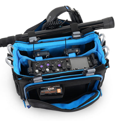 Audio mixer bag open to reveal mixing console layout; black case with blue interior compartments