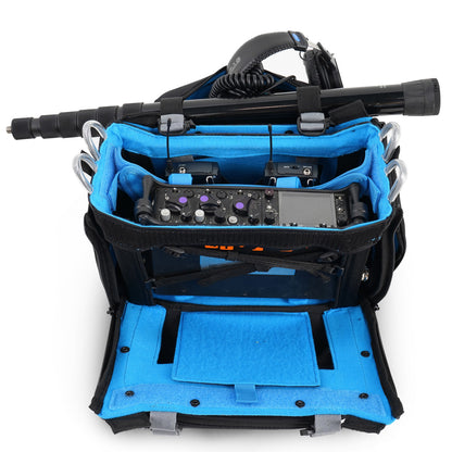 Audio mixer bag open with mounted controls; black exterior and blue inner lining with cables