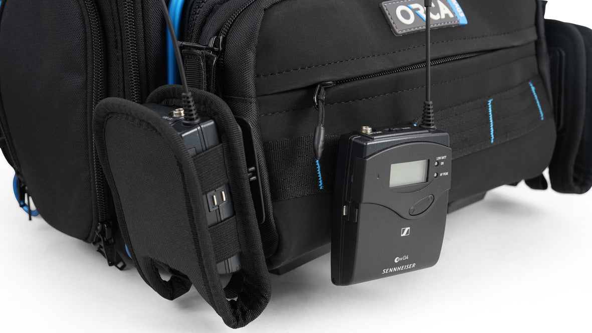 Audio mixer bag with detachable front panel; black exterior and blue interior, with audio device mounted