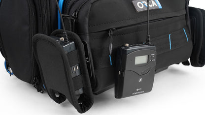 Audio mixer bag with detachable front panel; black exterior and blue interior, with audio device mounted