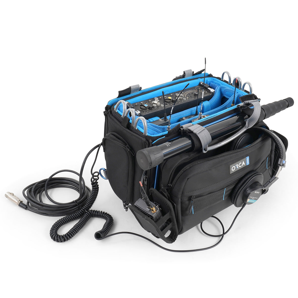 Audio mixer bag with internal rack, black exterior, and connected cables at front.