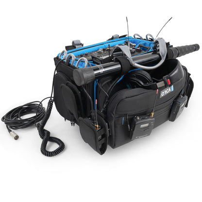 Audio mixer bag side view with blue interior and attached gear, cables visible