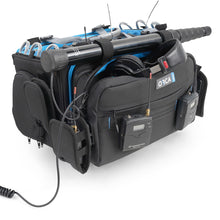 Black audio mixer bag with blue accents, side pockets, and cables on the top rail