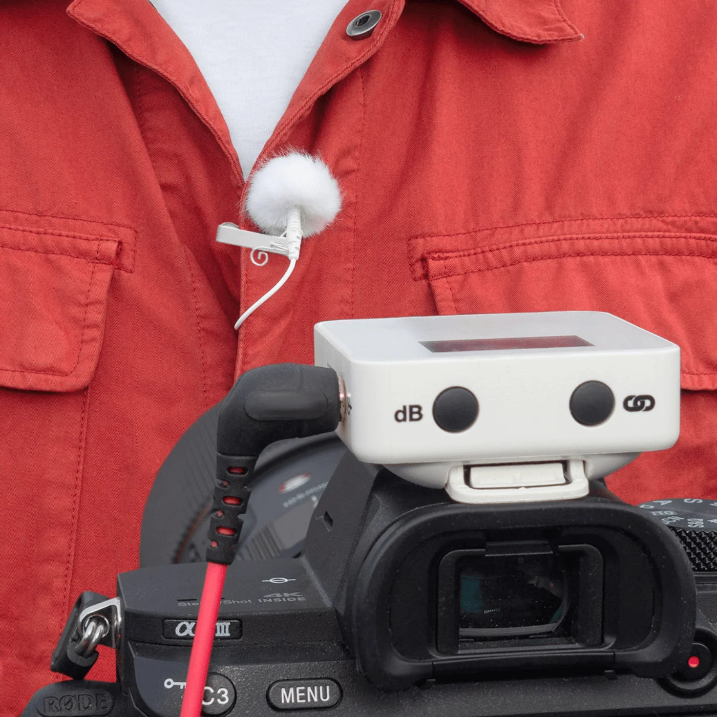 Outdoor mic kit on a red jacket with foam mic and small transmitter