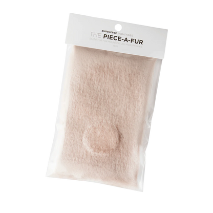 Beige faux fur patch with adhesive backing and round cutout for mounting