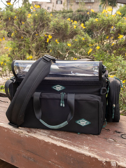 Large audio mixer recorder case with clear rain covers, front pockets, and shoulder strap
