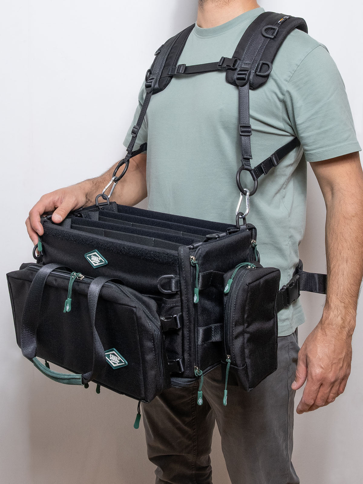 Black multi-pocket harness with front straps, D-rings, and side attachment points