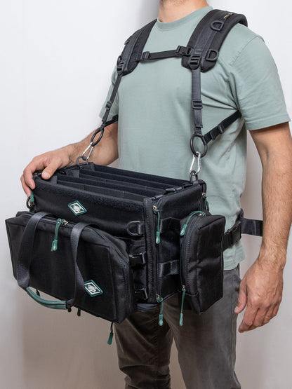 Black multi-pocket harness with front straps, D-rings, and side attachment points